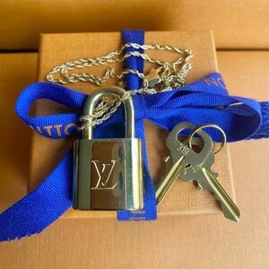 Louis Vuitton New, lock and key necklace. Hard to find! Authentic.